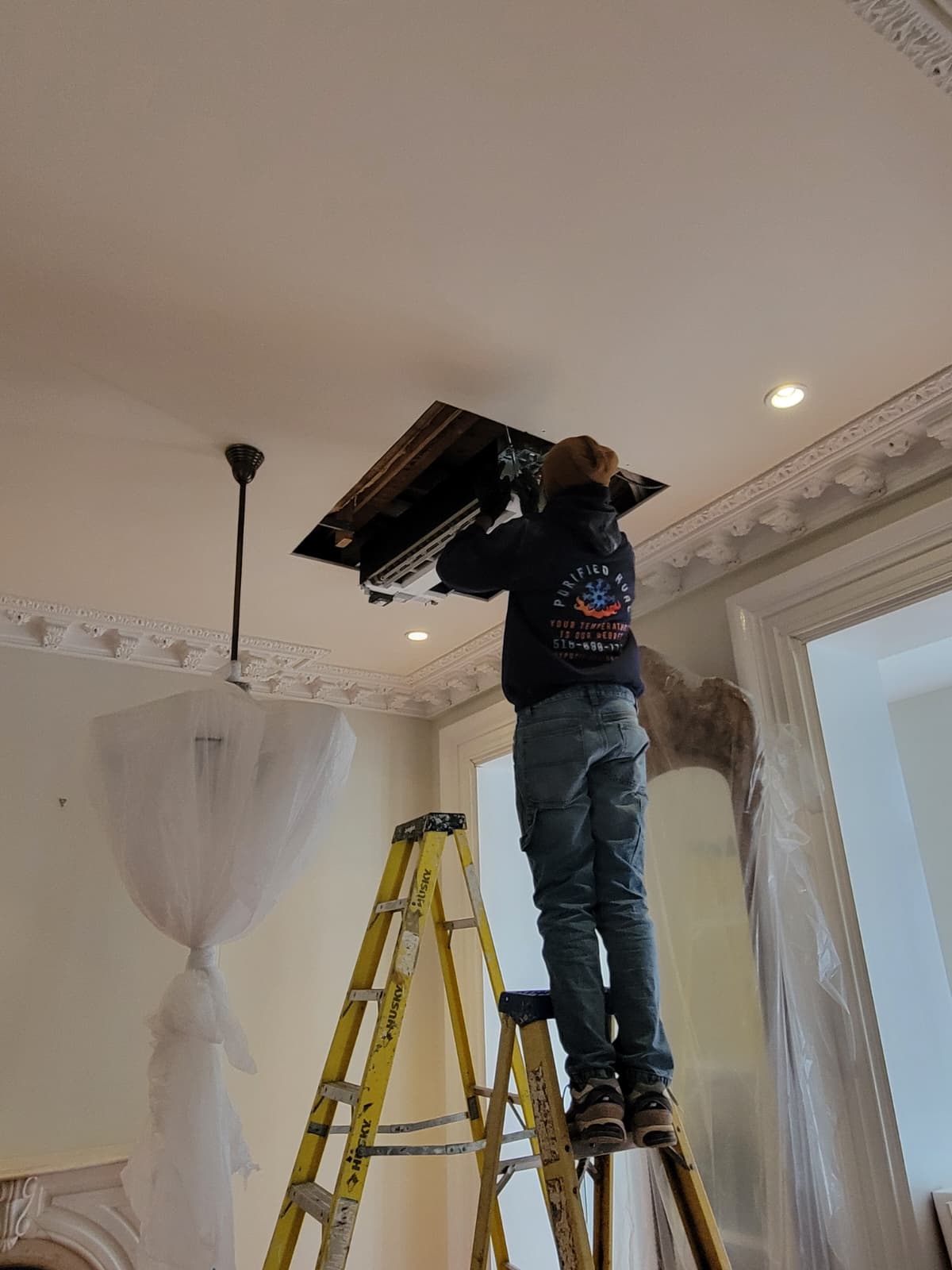 Technician on a Brooklyn rooftop or mechanical room